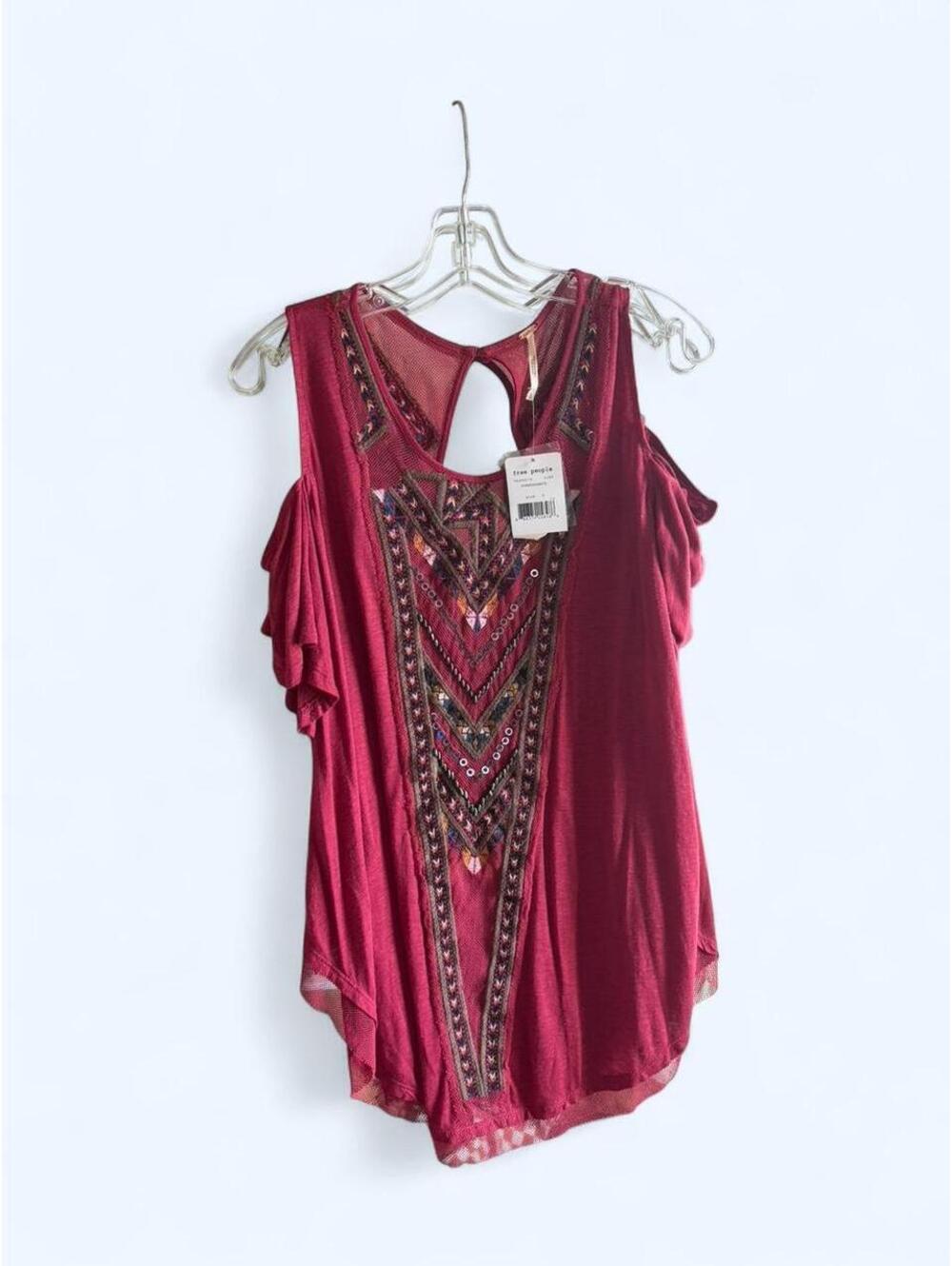 Free People red blouse with sequin details and cut out back.